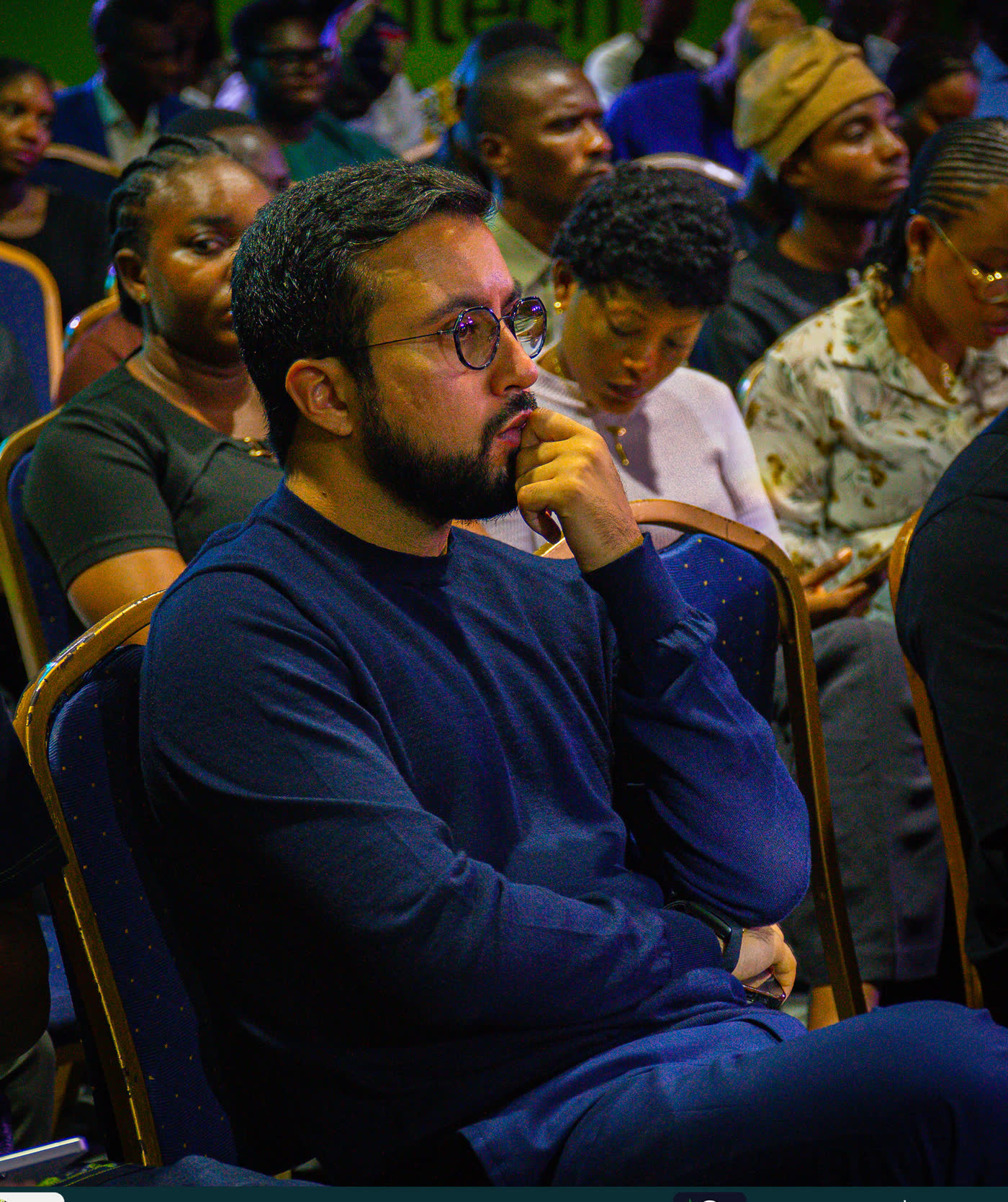 An attendee listening at NBA Week 2025